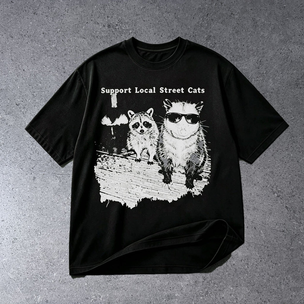 SUPPORT LOCAL STREET CATS FUNNY WILDLIFE GRAPHIC T-SHIRT on light gray concrete